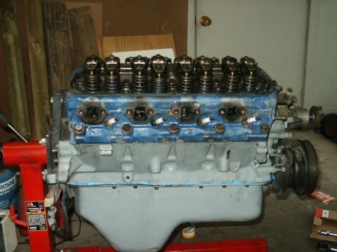 1991 Ford Bronco - Engine block on a stand, likely for rebuild or repair. The V8 configuration is visible with spark plugs in place.