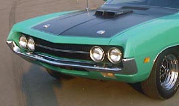 1971 Ford Ranchero - Front view of a green 1971 Ford Ranchero, highlighting its distinctive grille and dual headlights.