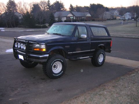 1994 Ford Bronco - This 1994 Ford Bronco features a prominent brush guard and large off-road tires, suggesting it's ready for adventure.