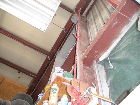 1993 Ford C-350 (Centurion Conversions) - Workshop hoist mechanism with red rope and spool mounted on steel beams.