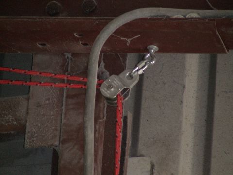 1993 Ford C-350 (Centurion Conversions) - A close-up view of a pulley system with red rope, attached to a metal structure.