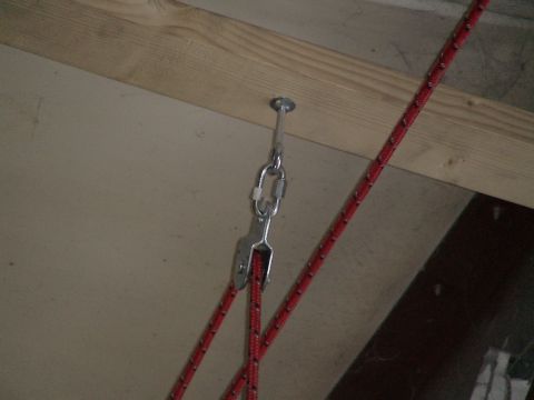 1993 Ford C-350 (Centurion Conversions) - A close-up view of a ceiling-mounted hoist system with metal hardware and red rope.
