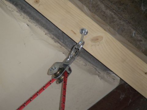 1993 Ford C-350 (Centurion Conversions) - A close-up view of a pulley system with red rope, mounted on a wooden beam.
