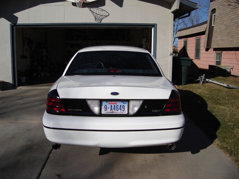 Rear view of a white 2000 Ford Crown Victoria parked in front of a garage. Nevada license plate 9-A4649