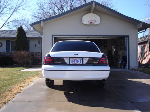 2000 Ford Crown Victoria - Rear view of a white 2000 Ford Crown Victoria parked in a driveway.