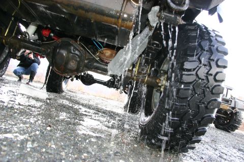 2003 Jeep TJ - Close-up view of a vehicle's rear axle and tire, with water dripping from ice.
