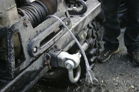 2003 Jeep TJ - Vehicle winch and tow hook assembly, showing a frayed cable and mounting hardware.