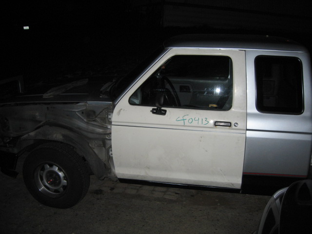 White extended-cab pickup at night, side view, front bodywork removed, 'CF0413' written on door