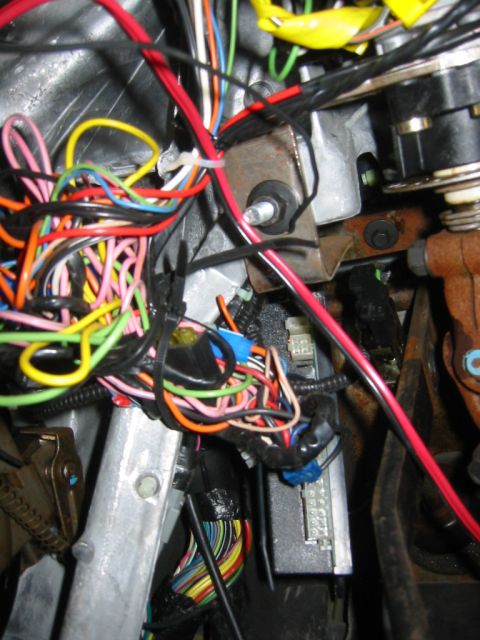 1995 Ford Bronco - A complex and tangled wiring harness is visible, with numerous colorful wires bundled together.