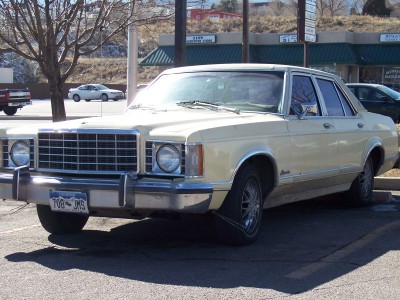 1972 Ford Ranchero - This sedan has a prominent chrome grille and a license plate reading "700 JHS".