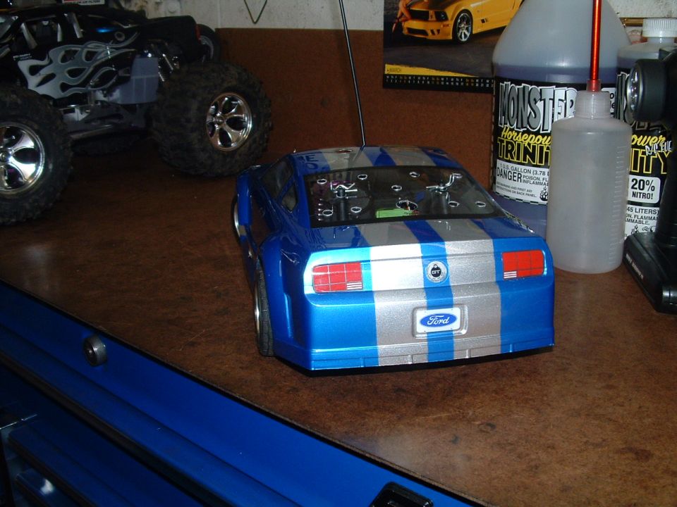 Blue and silver striped remote control car with Ford badging, rear view