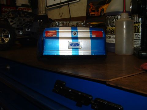 1994 Ford Bronco - Rear view of a blue and silver striped RC car with a Ford emblem on the trunk.