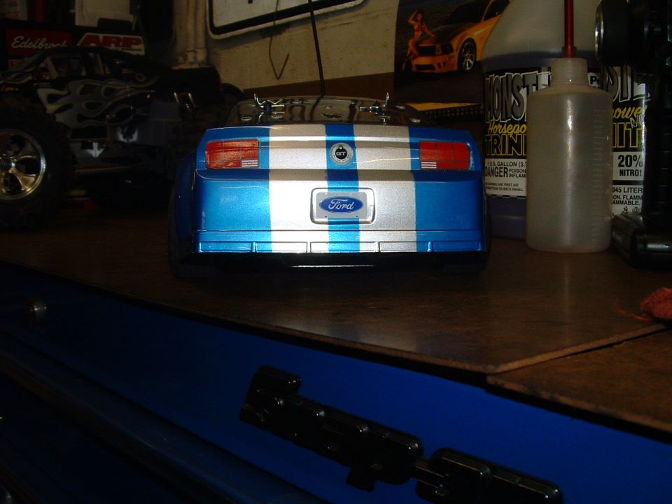 Blue and silver striped remote control car rear with Ford logo. Other RC car visible