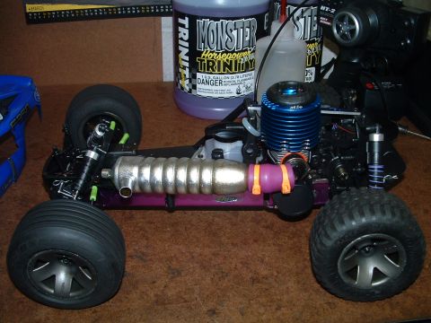 1994 Ford Bronco - A nitro-powered remote control monster truck is shown from the side, a prominent engine and exhaust system.