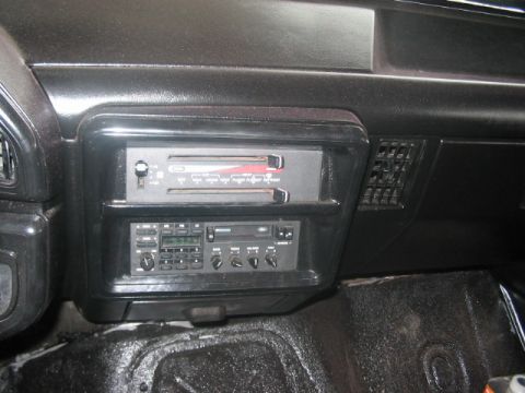 1991 Ford Bronco - Vehicle interior shows a car radio and dashboard vent. Year is not determinable from the image.