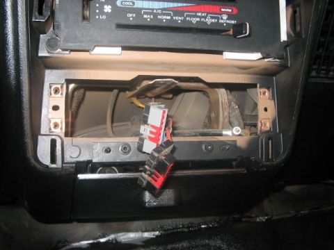 1991 Ford Bronco - The interior of a vehicle shows exposed wiring and connectors in the dashboard area, suggesting a repair or modification.
