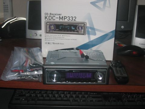 1991 Ford Bronco - A Kenwood CD-Receiver KDC-MP332 car stereo is shown with its accessories and packaging.