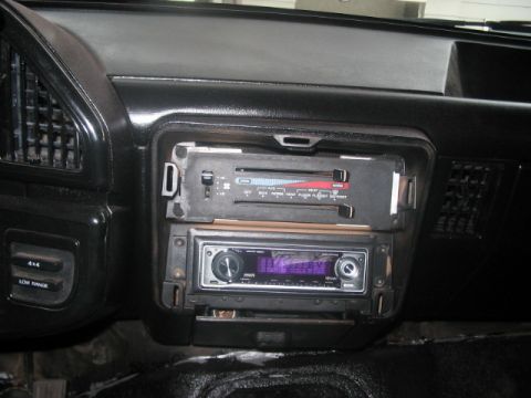1991 Ford Bronco - Interior view of a vehicle's dashboard, climate controls and an aftermarket stereo system. A 4x4 Low Range button is also visible.