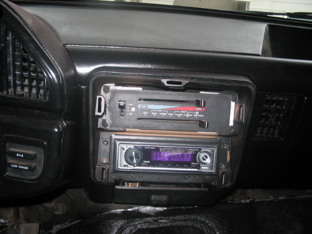 Dashboard interior with climate controls and aftermarket stereo. 4x4 Low Range button visible