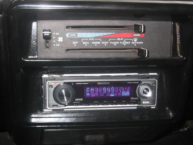 Kenwood car stereo installed in dashboard with climate controls above