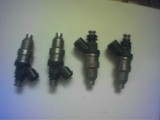 1993 Ford Probe - Set of four fuel injectors, likely for a car engine.