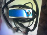 1993 Ford Probe - This is a car stereo head unit with a blue and silver finish, a control knob and attached wiring harness.