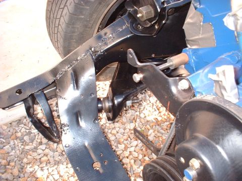 1964 Ford Galaxie - Detail of a vehicle's chassis and suspension system, with a tire visible in the upper left corner.