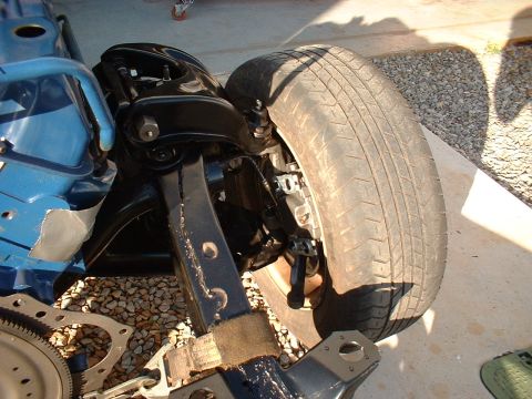 1964 Ford Galaxie - Front suspension components and tire of a vehicle are shown in detail.