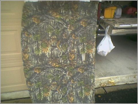 1981 Ford Bronco - Camouflage fabric and a plastic bag are visible next to a vehicle's open tailgate.
