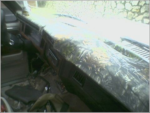 1981 Ford Bronco - The interior dashboard of a vehicle is covered in a camouflage wrap.