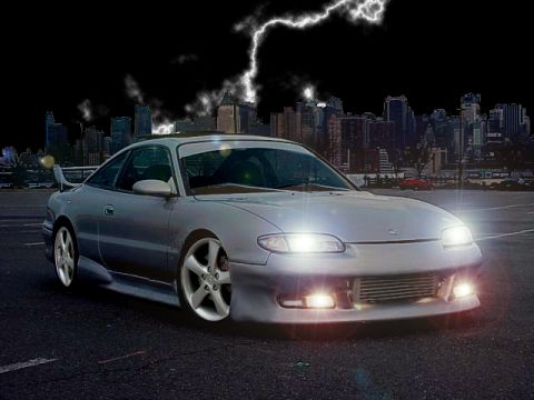 1994 Ford Probe - A modified Mazda MX-6 is shown in front of a city skyline during a thunderstorm.