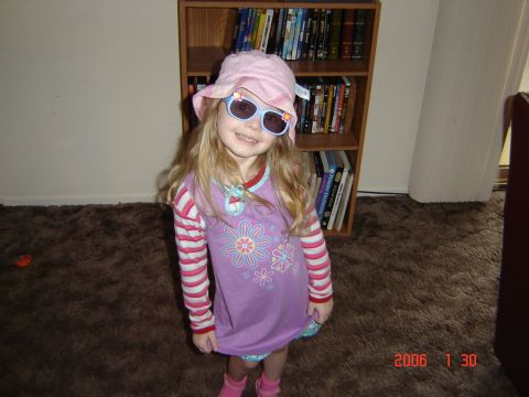 1993 Ford Bronco - A young girl poses for a photo indoors, wearing a pink hat and sunglasses.