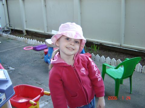 1993 Ford Bronco - A young girl wearing a pink hat and jacket poses for a photo in a backyard setting.