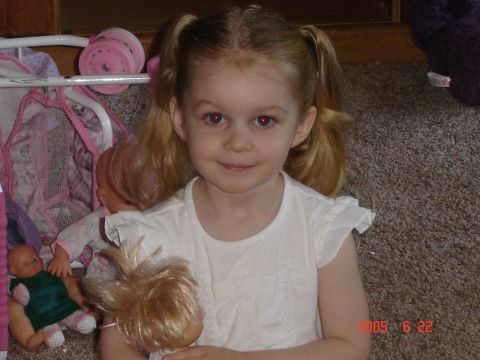 1993 Ford Bronco - A young girl with blonde pigtails holds two dolls while sitting on a carpeted floor. A Supermotors.net watermark is visible in the lower ri…