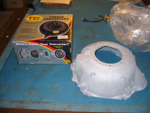 1985 Ford Crown Victoria LTD - A TCI torque converter box and an aluminum bell housing are displayed on a blue surface.