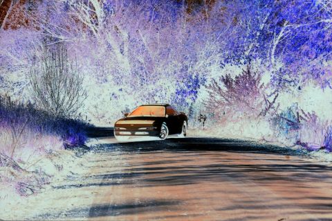 1996 Ford Probe - A Mazda MX-6 is seen on a rural road, with the surrounding foliage appearing in inverted colors.
