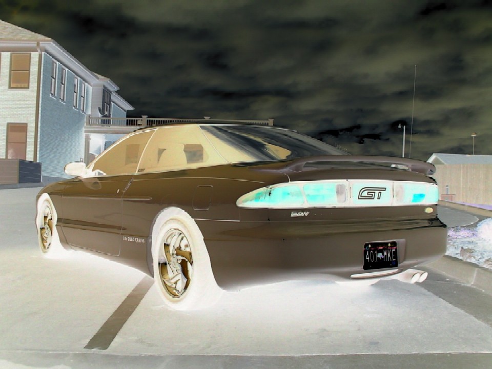 1996 Ford Probe GT rear view with GT badge on taillight panel and license plate 401-MXE