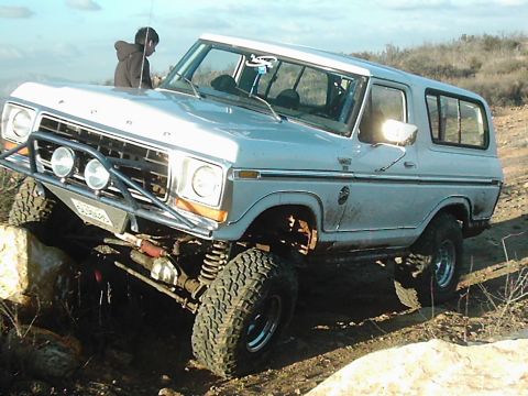 1978 Ford Bronco - A modified 1978 Ford Bronco navigates a rocky trail, demonstrating its off-road capabilities.