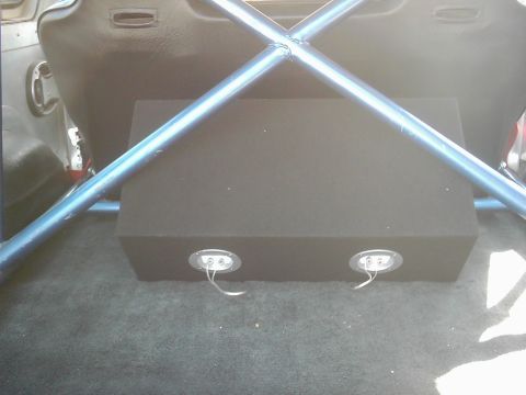 1978 Ford Bronco - Subwoofer box and roll cage visible in the rear interior of a vehicle.