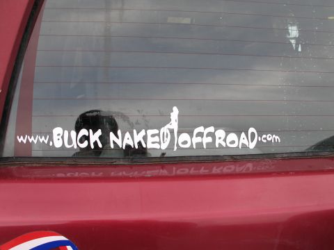 1995 Ford Bronco - A white sticker with the text 'www.BUCK NAKED OFFROAD.com' is applied to the rear window of a red vehicle.