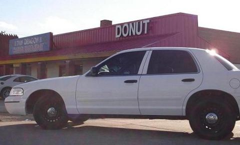 2000 Ford Crown Victoria - White 2000 Ford Crown Victoria parked in front of a donut shop.