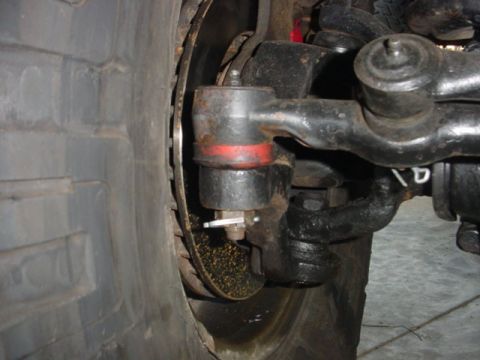 1988 Ford Bronco - Detail of a vehicle's suspension and steering components, including a tie rod end and ball joint.