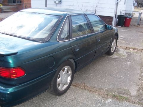 1993 Ford Taurus - This 1993 Ford Taurus sedan is shown from the rear three-quarter angle.