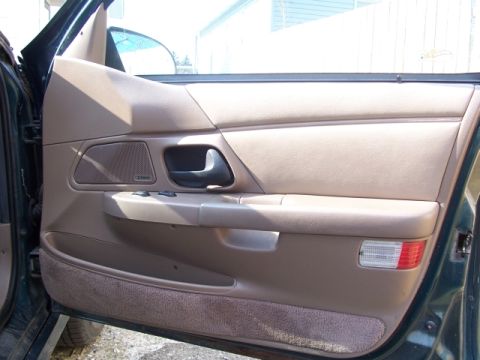 1993 Ford Taurus - Interior view of a 1993 Ford Taurus door panel, showing the speaker and door handle.