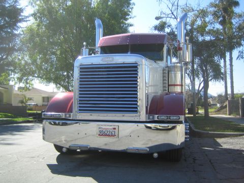 1968 Ford Mustang - This Peterbilt semi-truck is parked on a residential street on a sunny day.