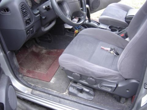 1999 Ford Taurus - The interior of a vehicle, the driver's seat and dashboard with keys on the seat.