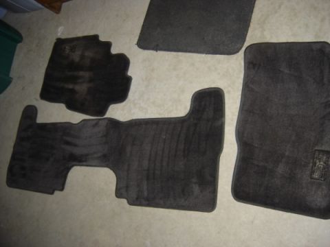 1999 Ford Taurus - Set of car floor mats, including a large rear mat and three front mats.