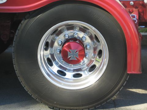 1968 Ford Mustang - Close-up of a large truck's wheel and fender, a decorative center cap.