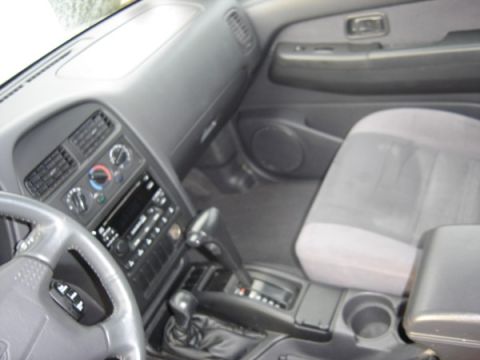 1999 Ford Taurus - Interior view of a vehicle's dashboard, center console, and passenger seat.