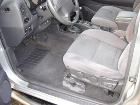 1999 Ford Taurus - Interior view of a silver SUV, highlighting the driver's side seat and dashboard controls.
